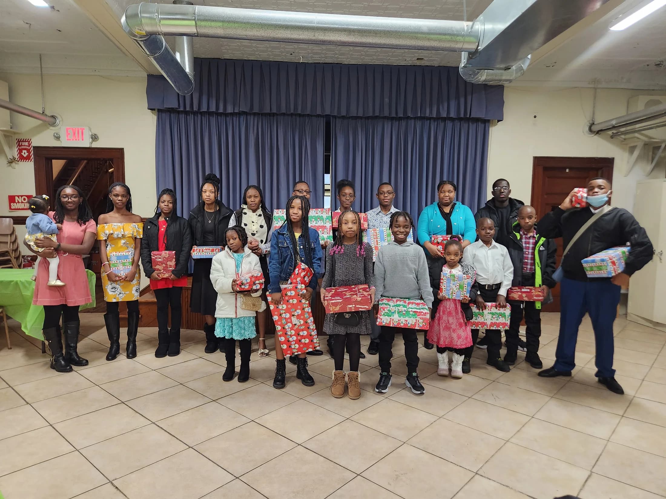 Children and young people holding their Christmas gifts at EBRC