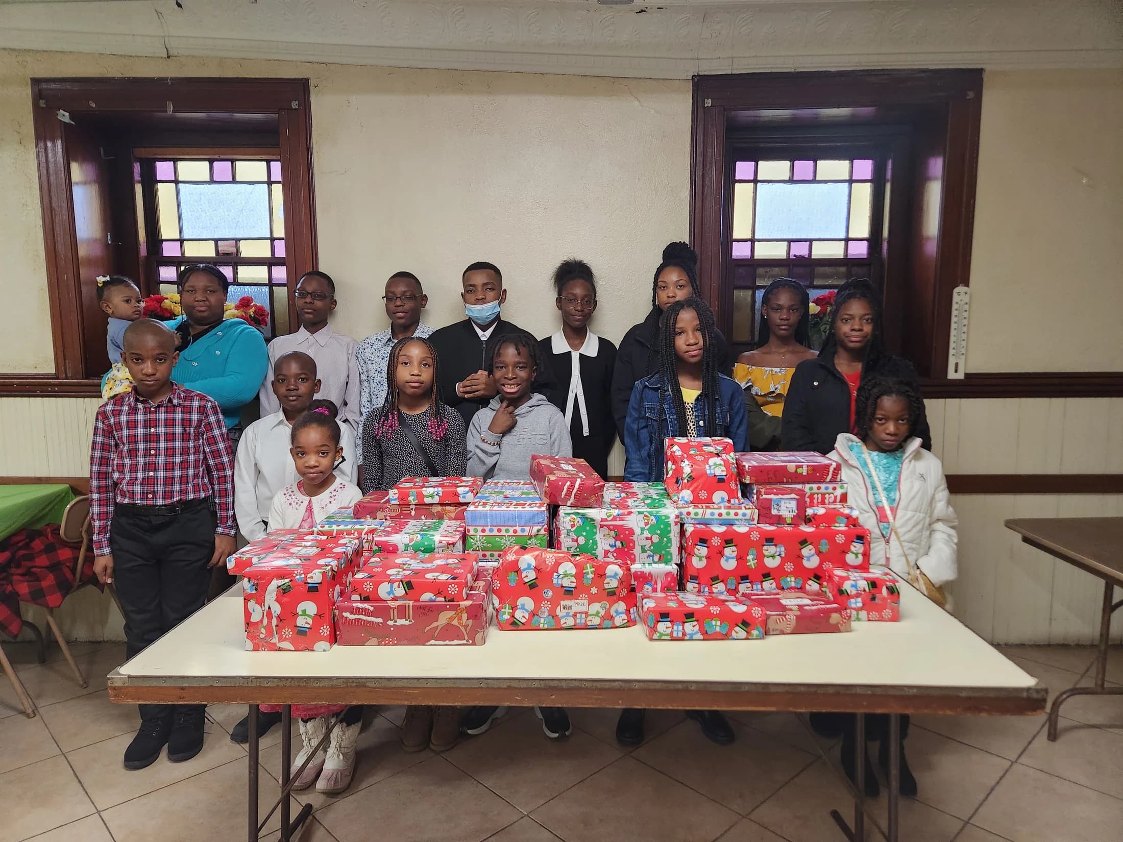 Church families gathered around the Christmas gift table