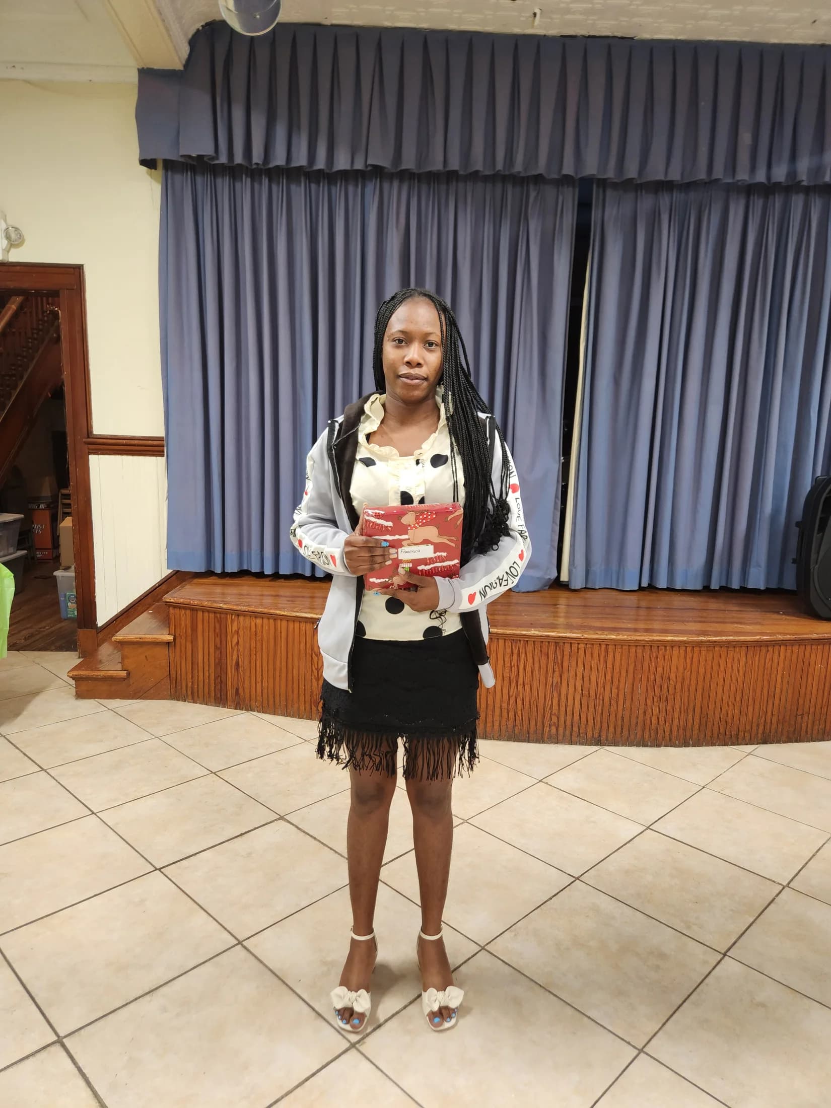 A young church member holding a Christmas gift
