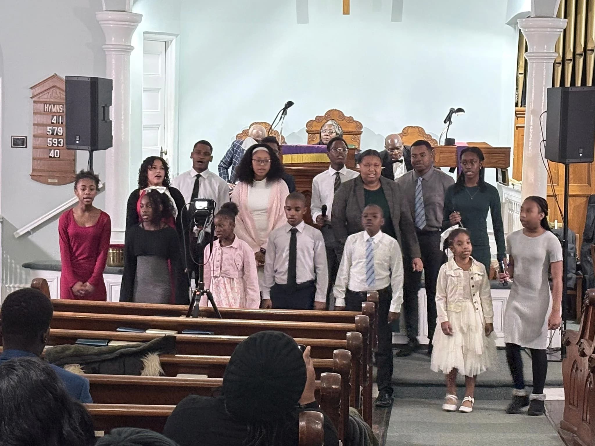 Children and youth singing together during the Christmas service