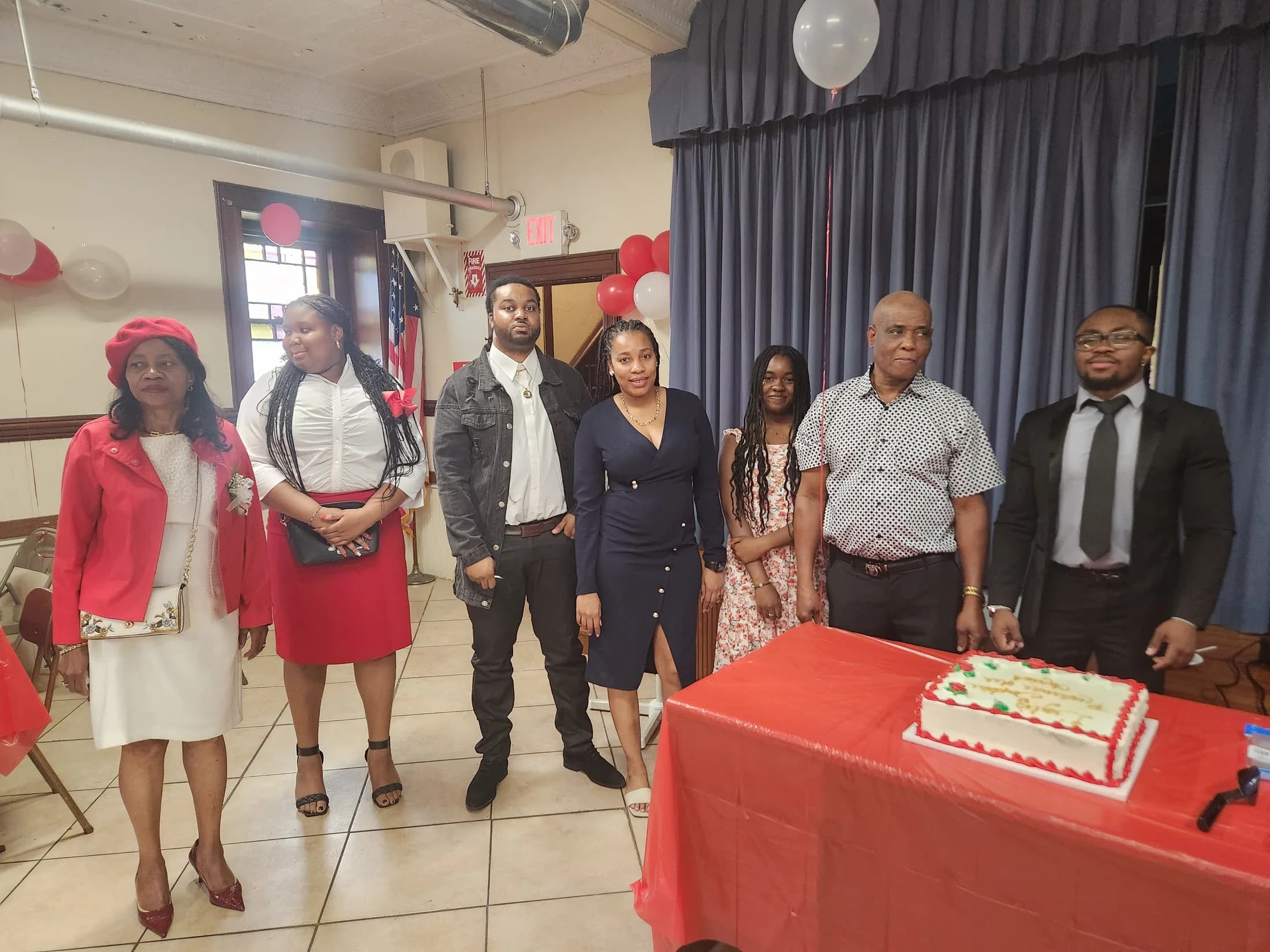 Church members gathered beside the inauguration celebration cake