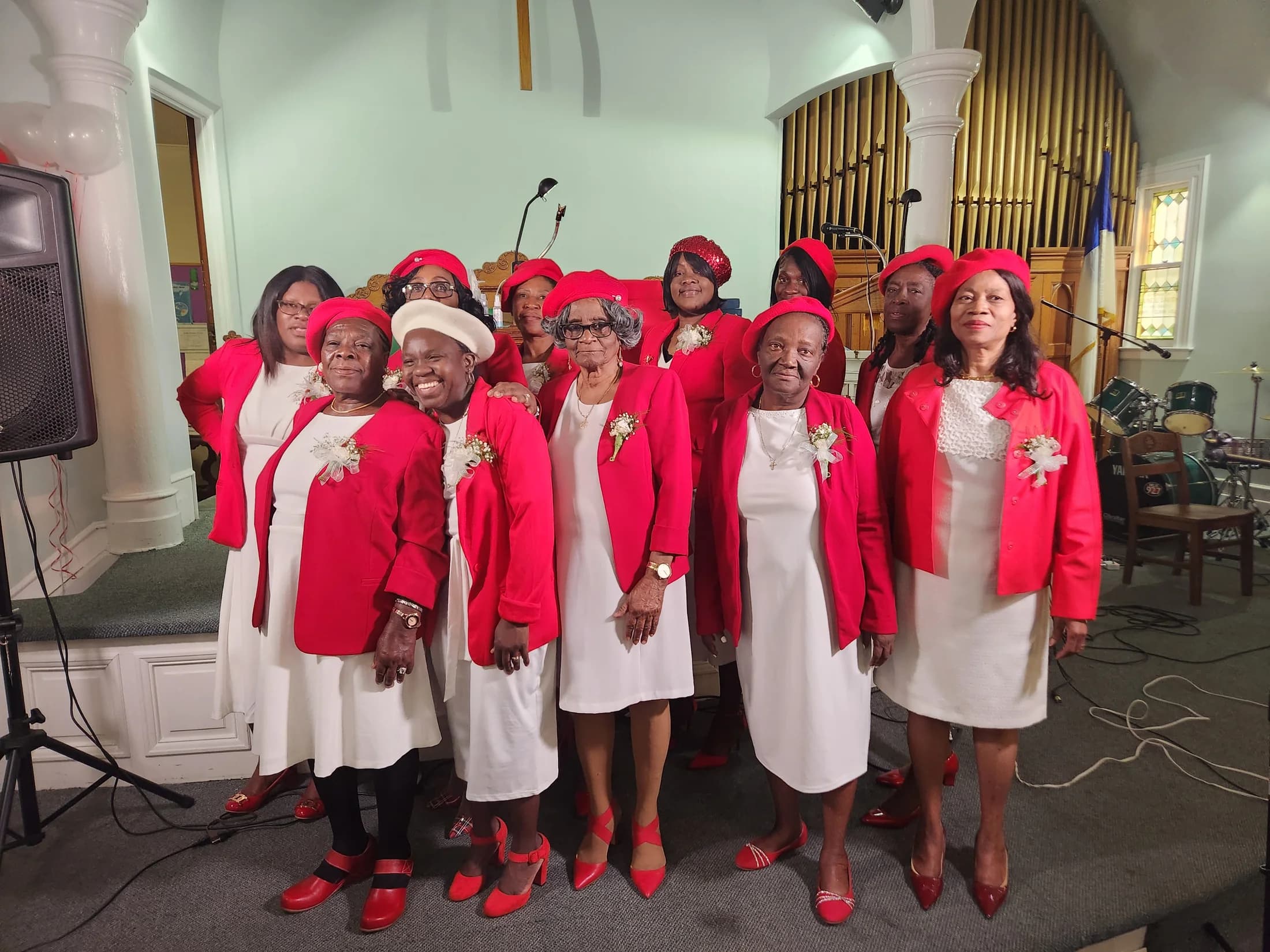 The EBRC women's choir standing together in red and white